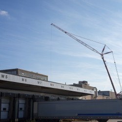 A 600-ton crane starts installing  200 pieces of structural steel to create a new conveyor enclosure on the Windsor Assembly Plant’s roof. 