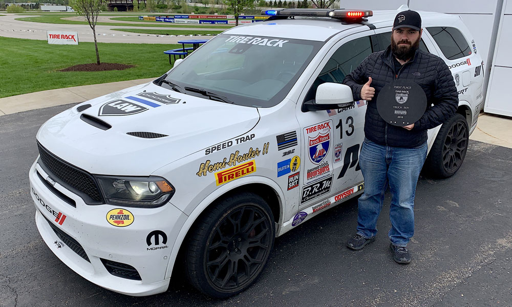 David Carr, SRT vehicle performance dynamics engineer and co-driver of the Dodge Durango SRT Pursuit concept nicknamed "Speed Trap" shows off the trophy for winning the Truck/SUV class in the 2019 One Lap of America.